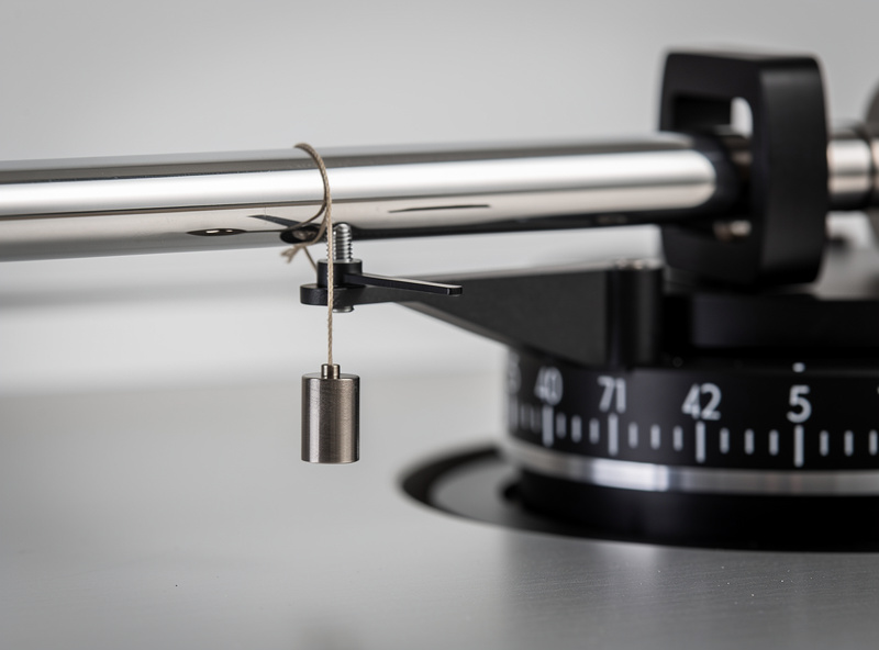 Close-up of anti-skate dial on turntable tonearm base