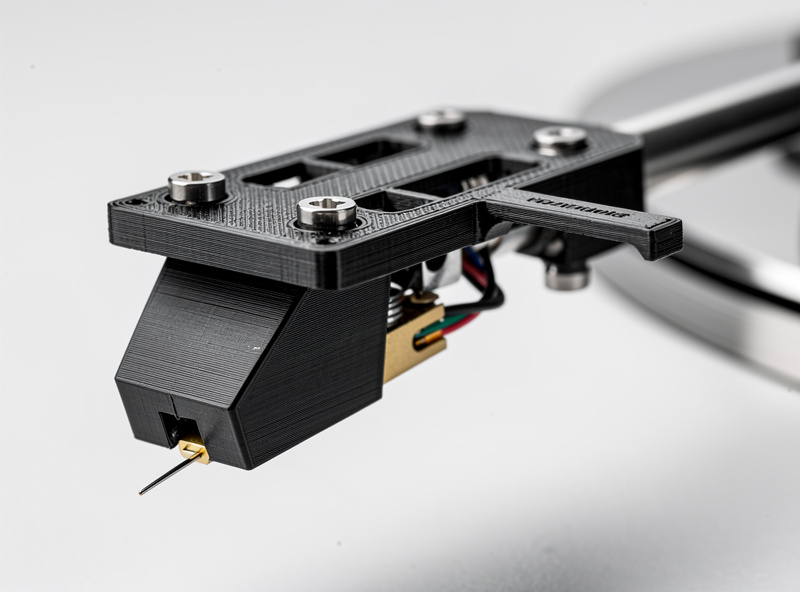 Macro shot of a black 3D-printed PETG headshell mounted on a turntable tonearm