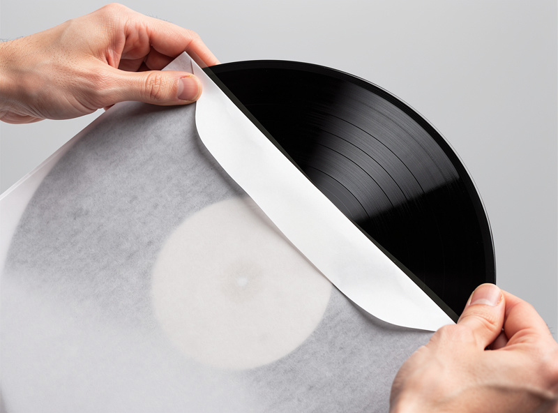 A vinyl record being slid into a soft anti-static inner sleeve