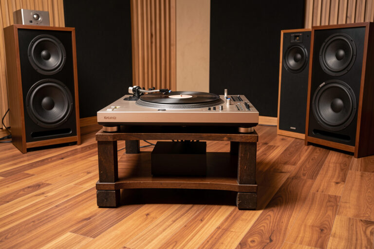 Turntable on a heavy low audio stand away from the speakers