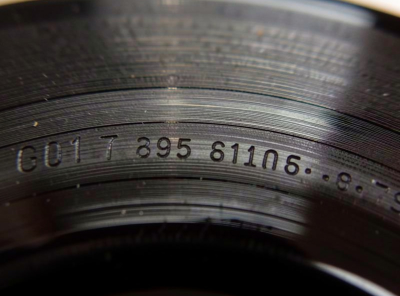 Close-up of dead wax run-out groove showing etched matrix numbers