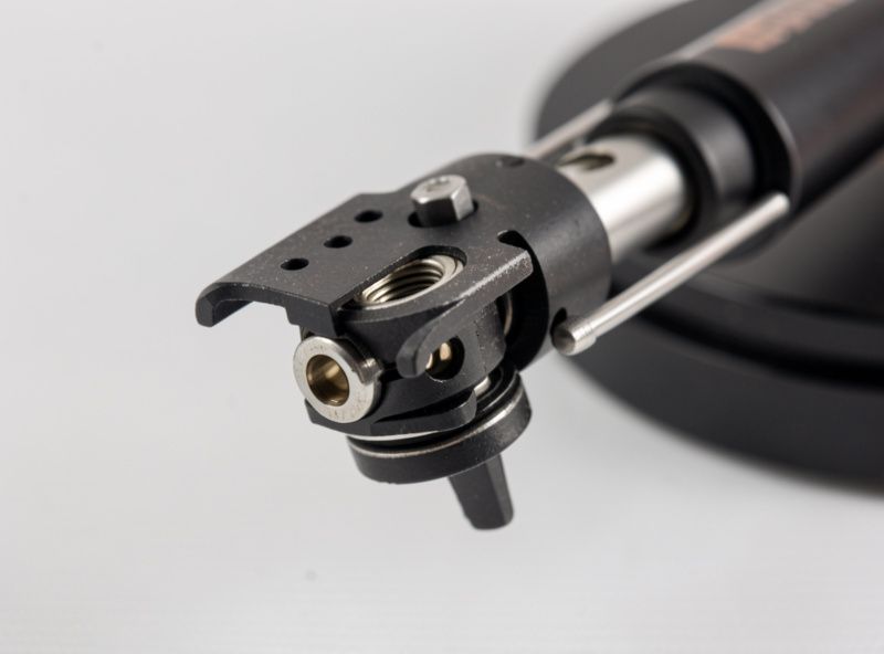 Close-up of a tonearm pivot bearing and anti-skate mechanism