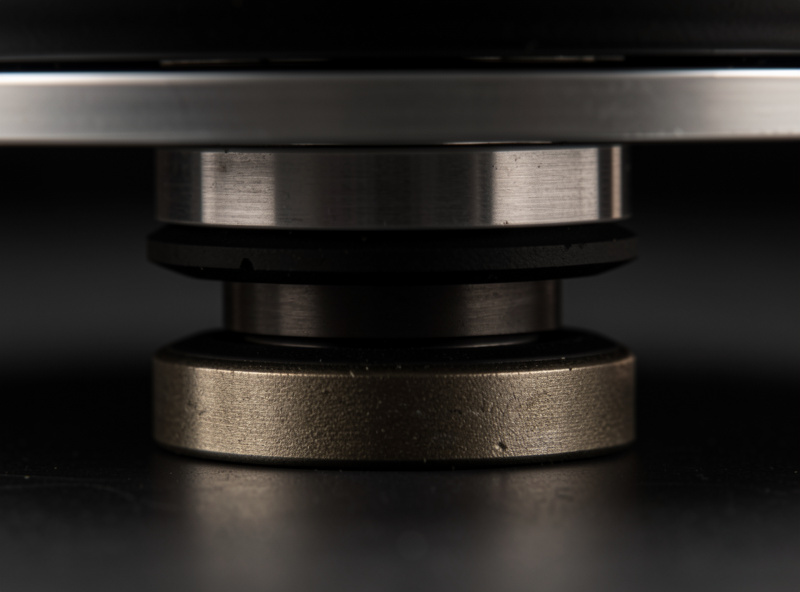 Close-up of spring absorber isolation feet supporting a turntable plinth