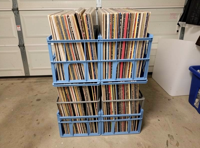 Stackable storage crates filled with vinyl records standing upright