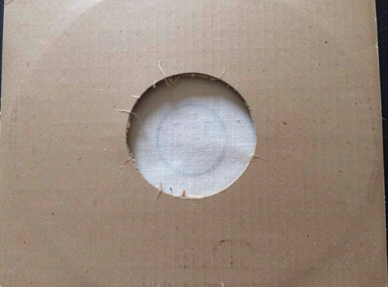 An album cover showing ring wear, a circular impression in the cardboard