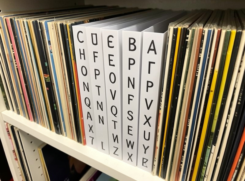 Rigid alphabetical divider cards standing between groups of vinyl records