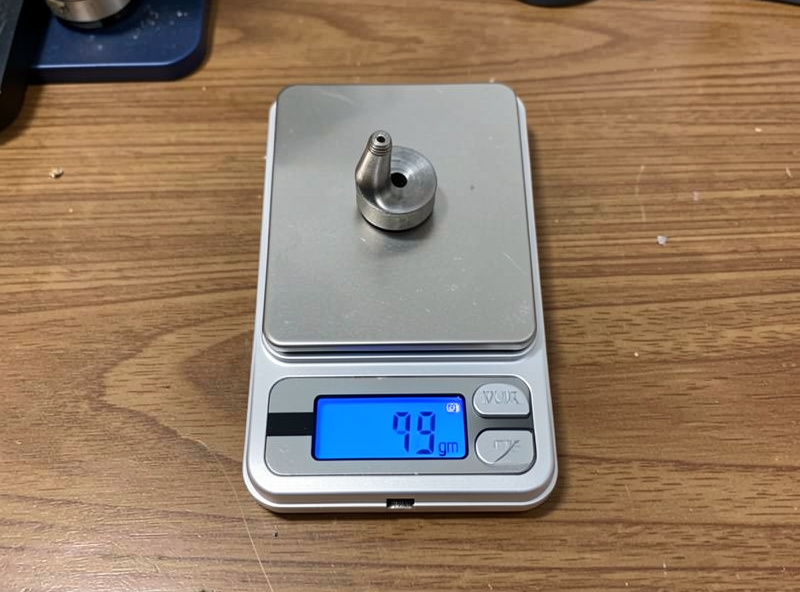 Digital jewelry scale weighing a turntable headshell showing grams on the display