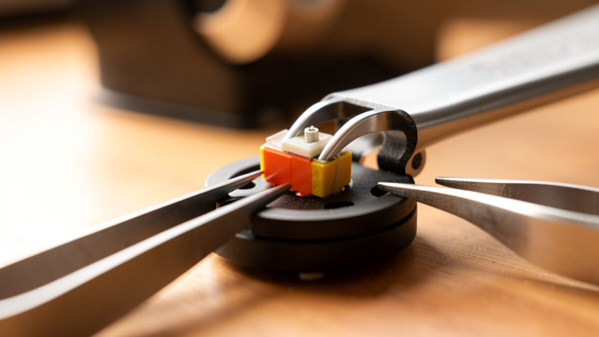 Thin shim spacers placed between a phono cartridge and a headshell to set vertical tracking angle