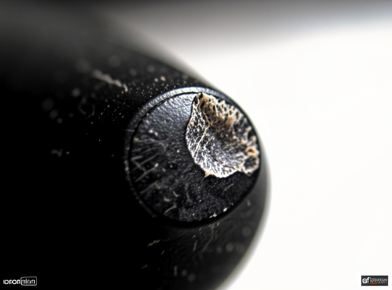 Macro close-up of a worn stylus tip showing a flattened contact patch