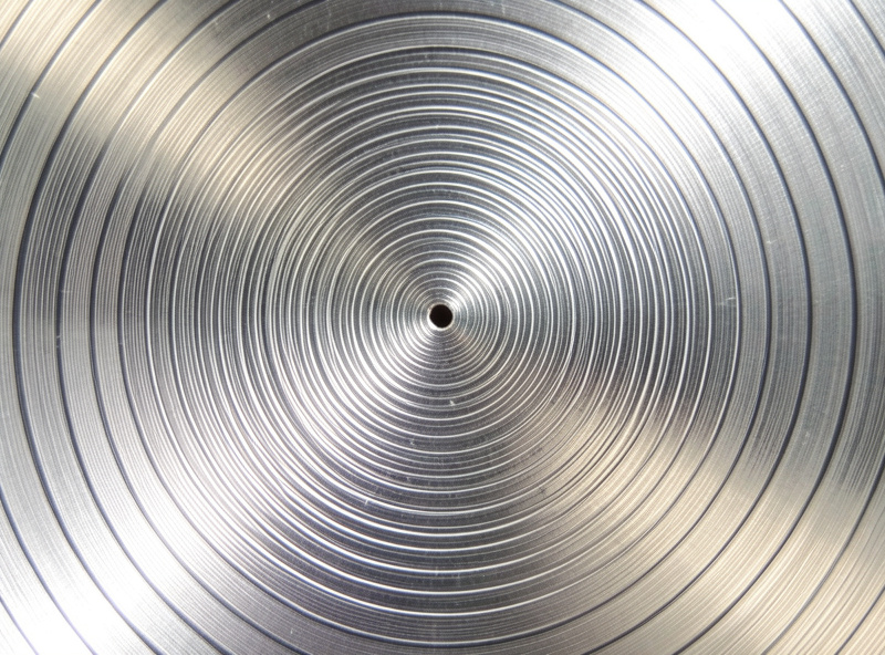 Macro view of vinyl record grooves tightening as they spiral toward the center label