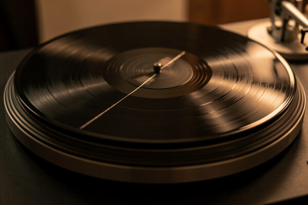 Vinyl record with a scratch catching the light on a platter
