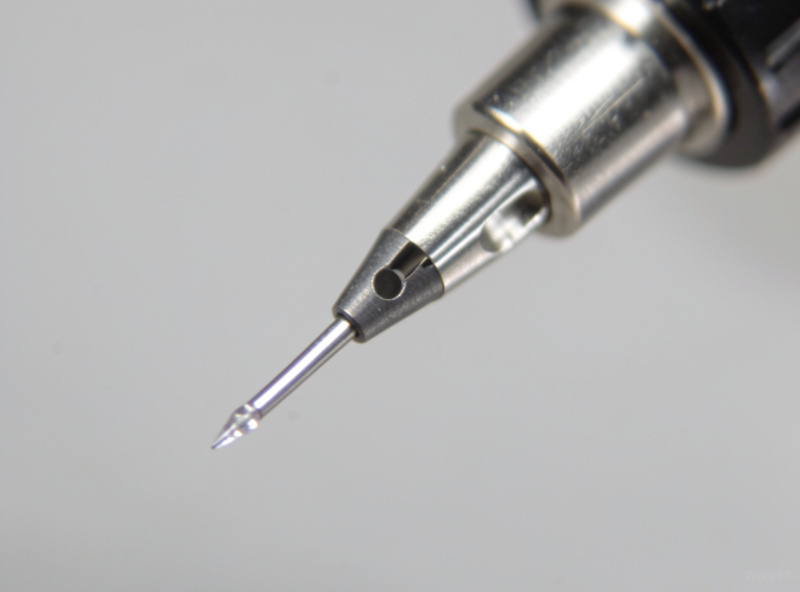 A phono cartridge stylus viewed under a USB microscope showing the diamond tip and cantilever