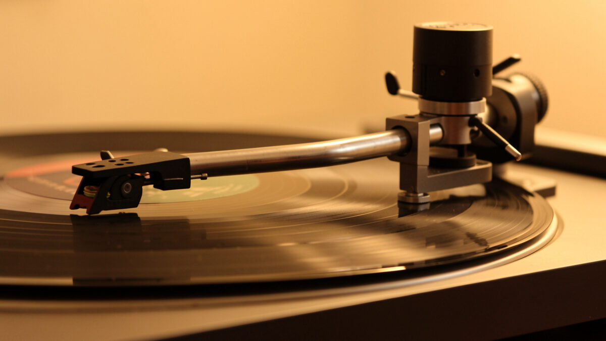 Turntable tonearm over a record showing pivot and counterweight