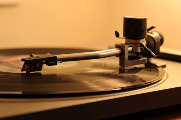 Turntable tonearm over a record showing pivot and counterweight