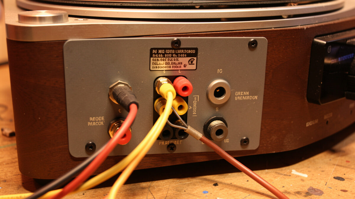 Rear of a turntable and amplifier with ground wire and cables